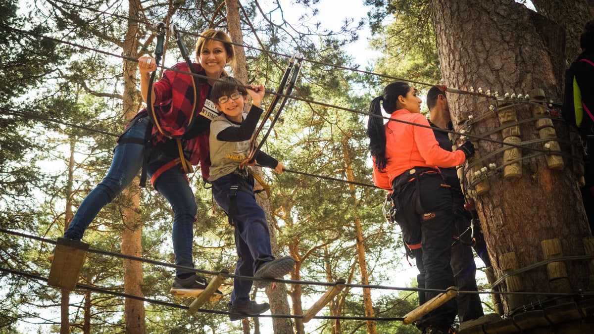 A family enjoys a thrilling day on a ropes course in Cercedilla, Spain.